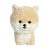 A soft Pomeranian plush toy from Aurora stuffed animals with golden fur and fluffy face.